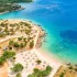 Luftaufnahme des Campingplatzes Olea in Kroatien mit türkisblauem Wasser, Sandstrand, Zelten und Wohnmobilen direkt am Meer, umgeben von mediterraner Vegetation